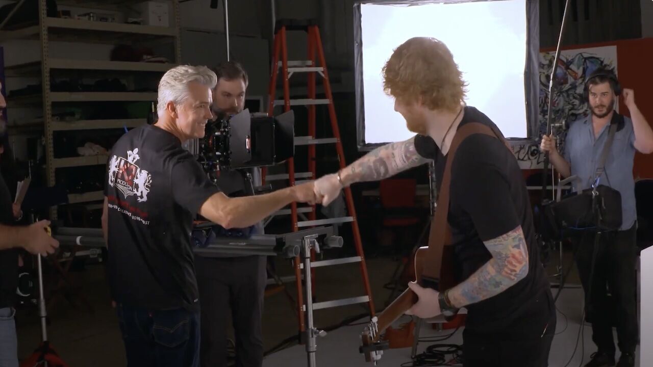 Ed Sheeran and K2's video director fist bumping on set.