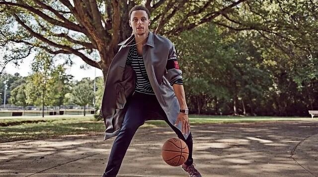 Stephen Curry playing with a basket ball in a park for a sports reel.